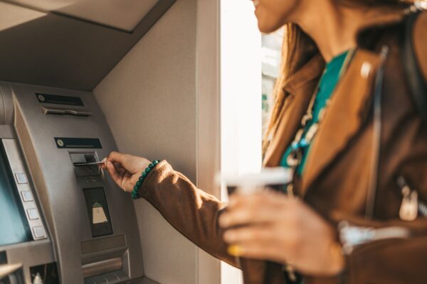 Handelsbanken - Woman taking out money from ATM using bank card