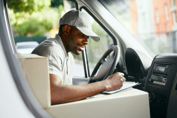 Bedrock Agent - Delivery driver sitting in van and filling out documentation for deliveries