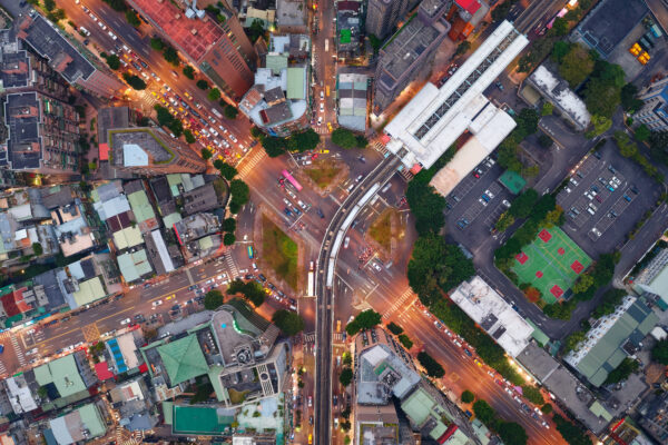 H3 Geospatial Tiling System - Top down view of a metro train arriving at an elevated station in Taipei